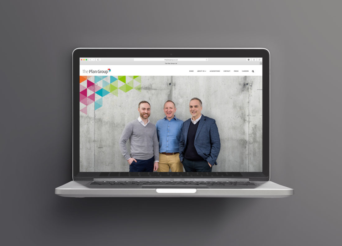 Laptop shows the homepage for The Plan Group. The hero image is of the three directors with a tessellated triangle pattern overlaid in the top-left corner