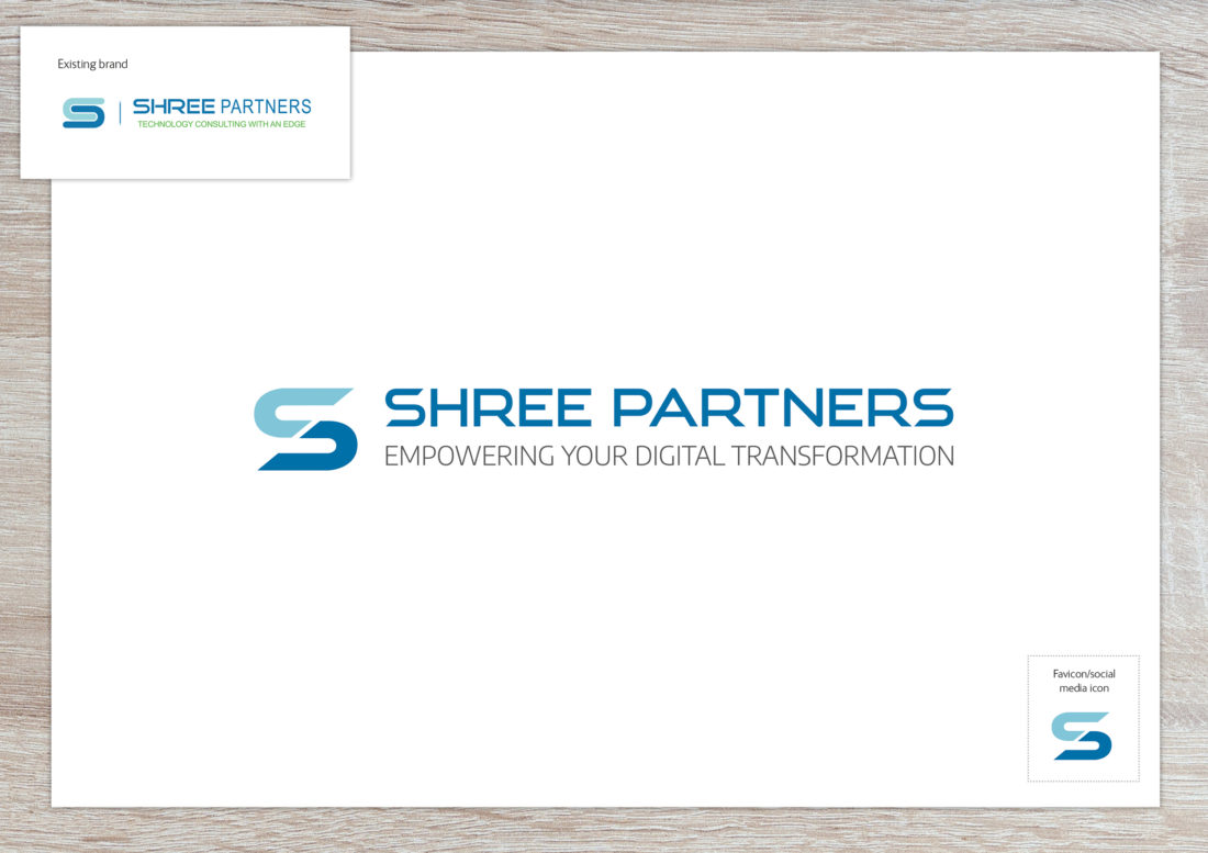 Shree Partners revised logo. Shree Partners is written in upper case in a modern, sans-serif typeface. To the left, a 'S' of the same typeface is sliced diagonally with the top half in light blue and the bottom half in mid-blue