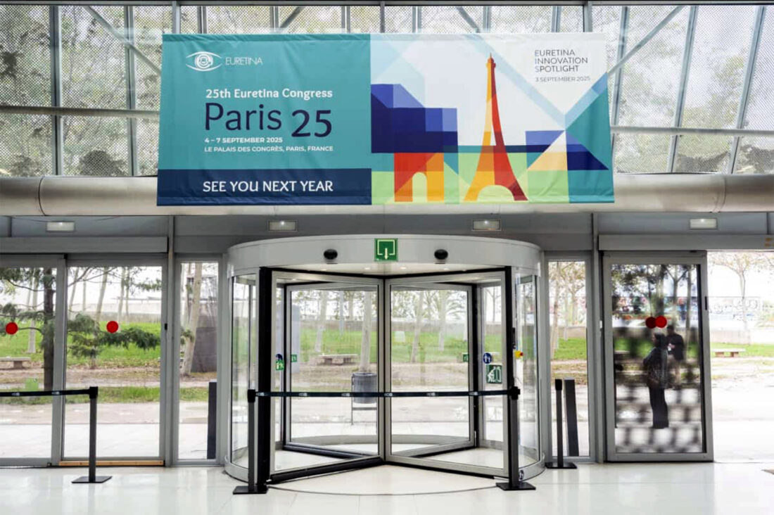 Entrance foyer with the event banner advertising next year's Congress above the rotating exit doors.